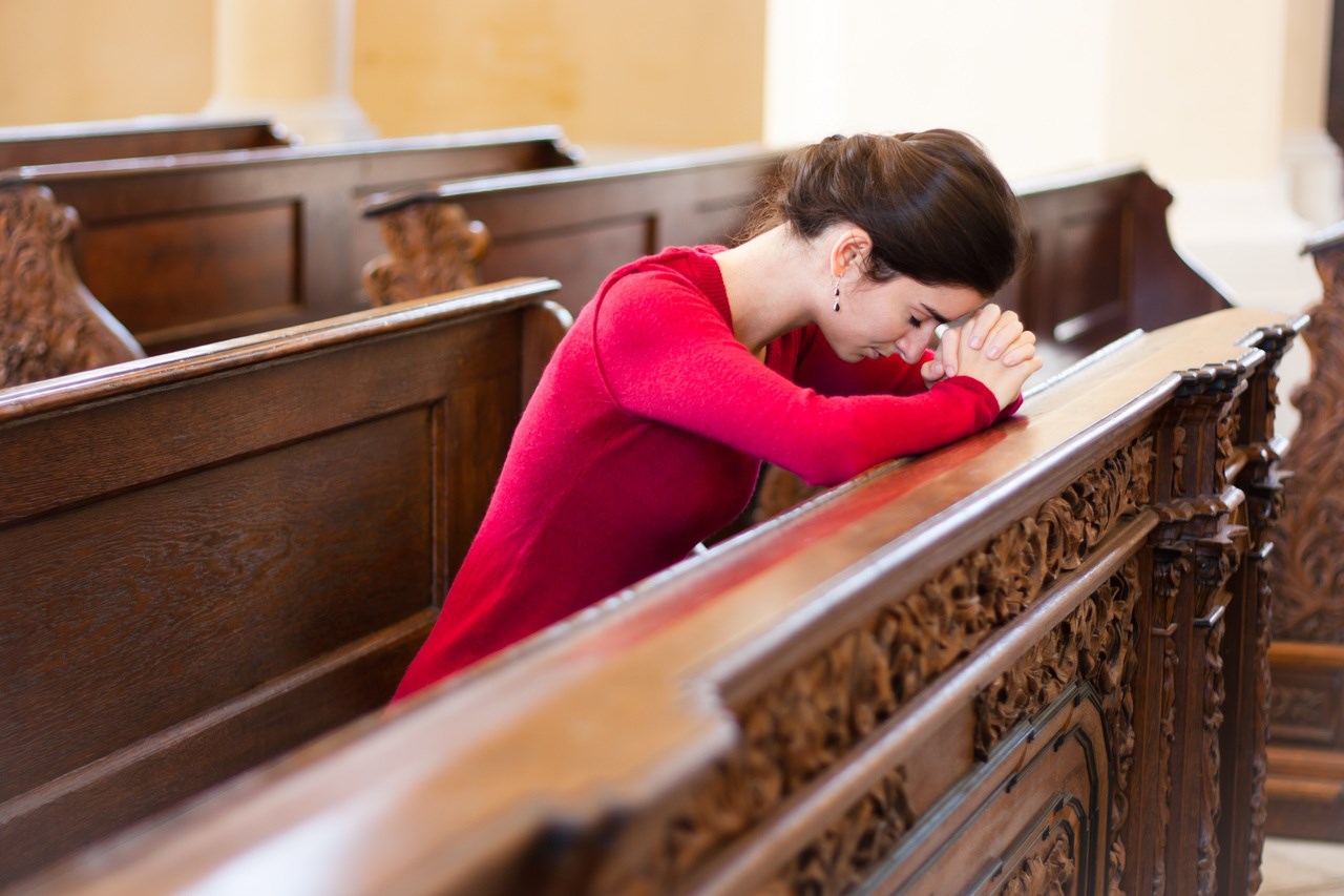A person praying in church, embracing meaningful life lessons.